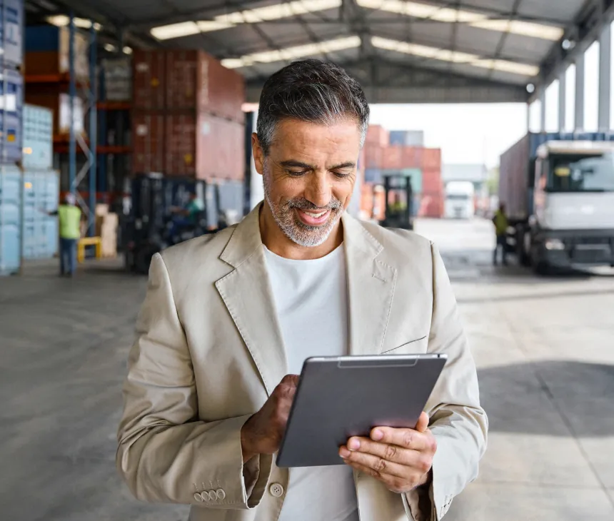 A manager reviewing a tablet in a distribution yard