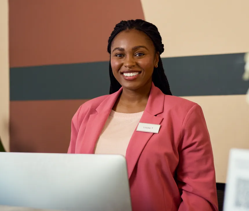 A professional working at a laptop in an office